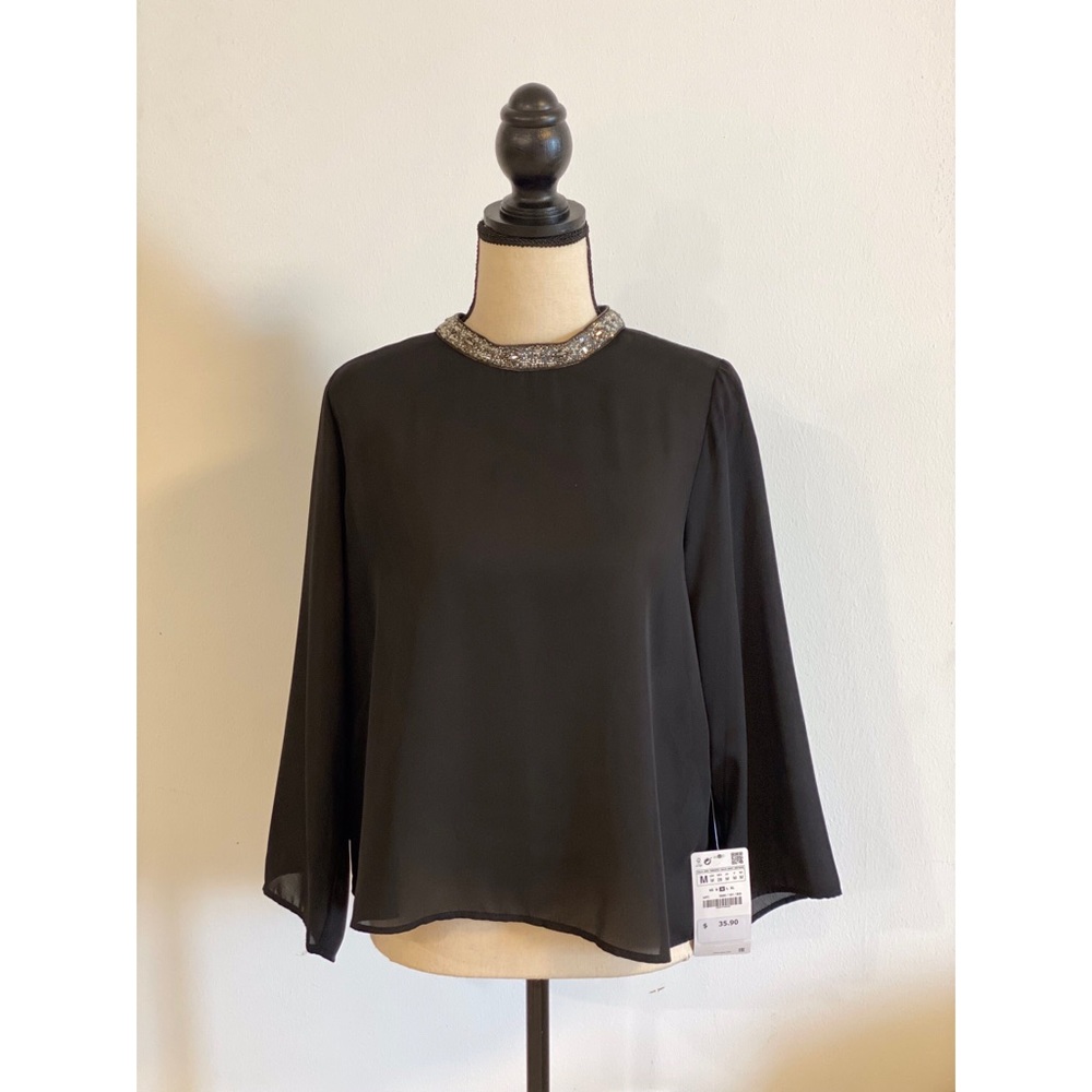 Blouse with neck embellishments